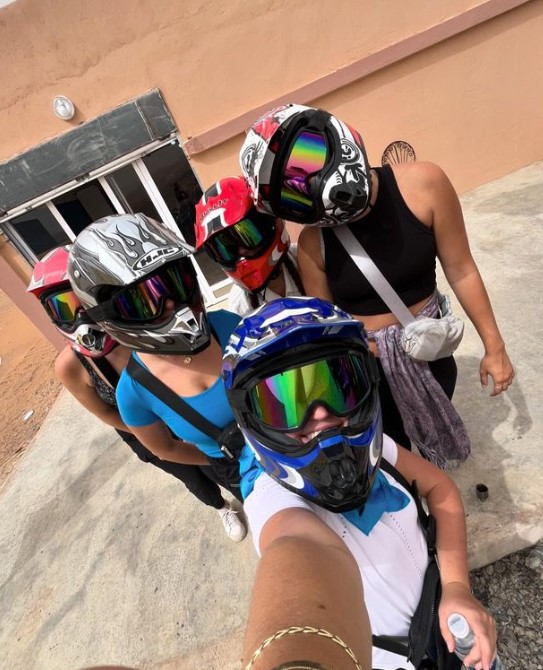 Riley, the writer, and four of her friends from Semester at Sea preparing to go ATV-ing in the Sahara Desert. They are wearing helmets, goggles, and athletic wear. This shows one of the most fun activities on Semester at Sea.