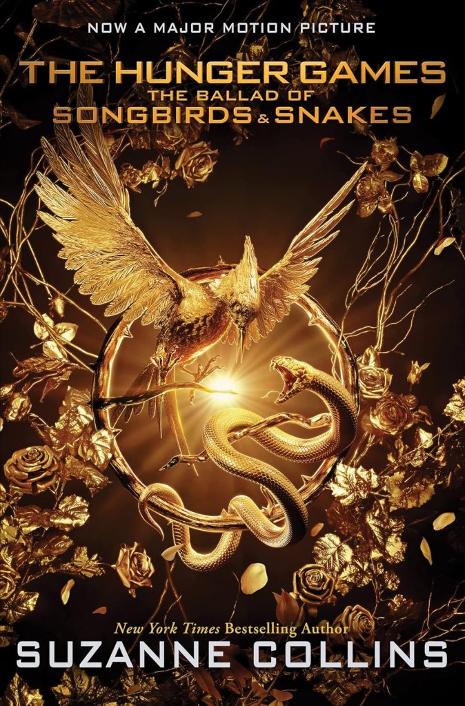 Book cover of 'The Hunger Games: The Ballad of Songbirds and Snakes' by Suzanne Collins, featuring a golden mockingjay bird and a snake entwined in a decorative floral design.